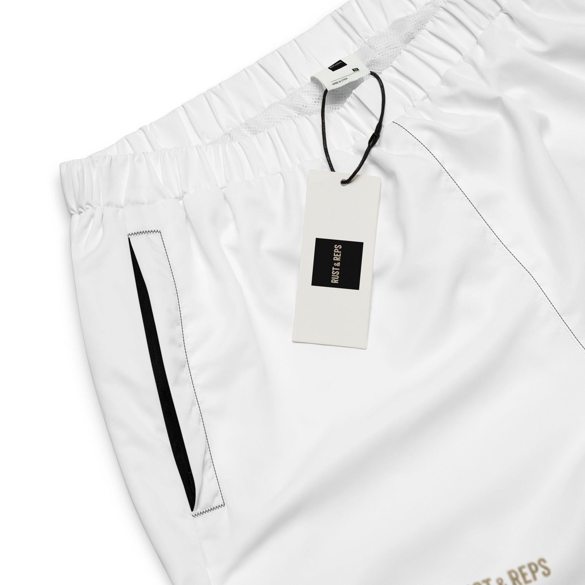 The Track Pants – front view, white, product label – rustNreps